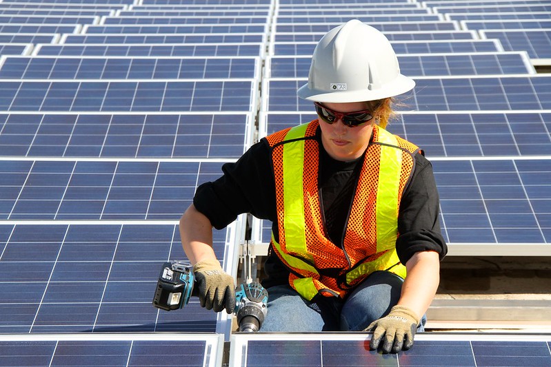 A Canadian worker installing PV modules. Source: Green Energy Futures, David Dodge, Flickr