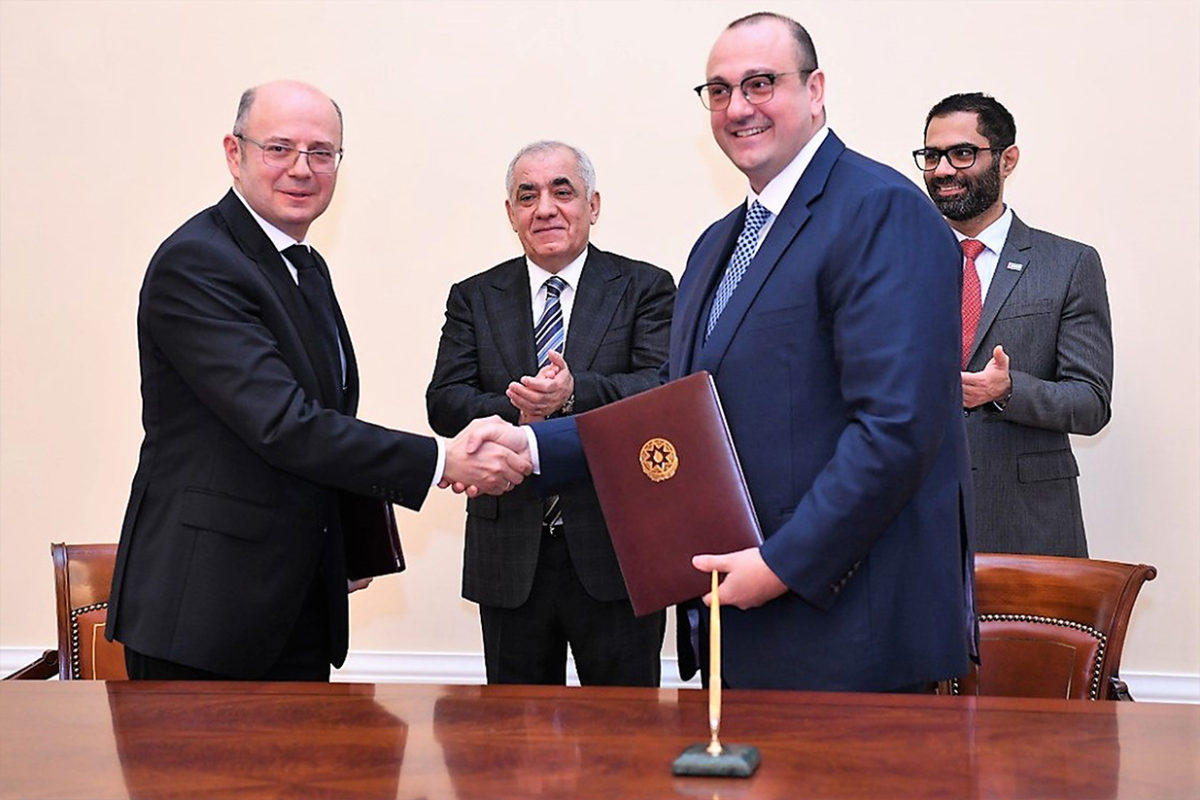 Azerbaijan's Energy Ministry Parviz Shahbazov (left) and Masdar's Mohammed Jameel Al Ramahi (second right) hail the deal at the signing ceremony (Image credit: Masdar)