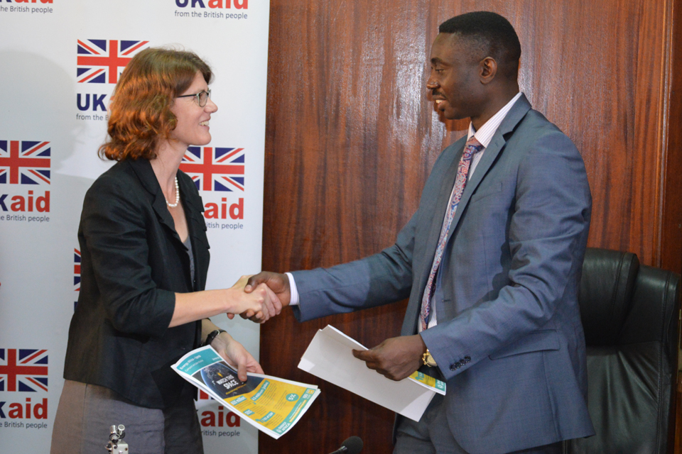 Head of DFID Uganda, Jennie Barugh and Dr Stephen Isabalija, Permanent Secretary at the Ugandan Ministry for Energy and Mineral Development exchange signed copies of the Energy Africa Compact last December. Credit: DFID