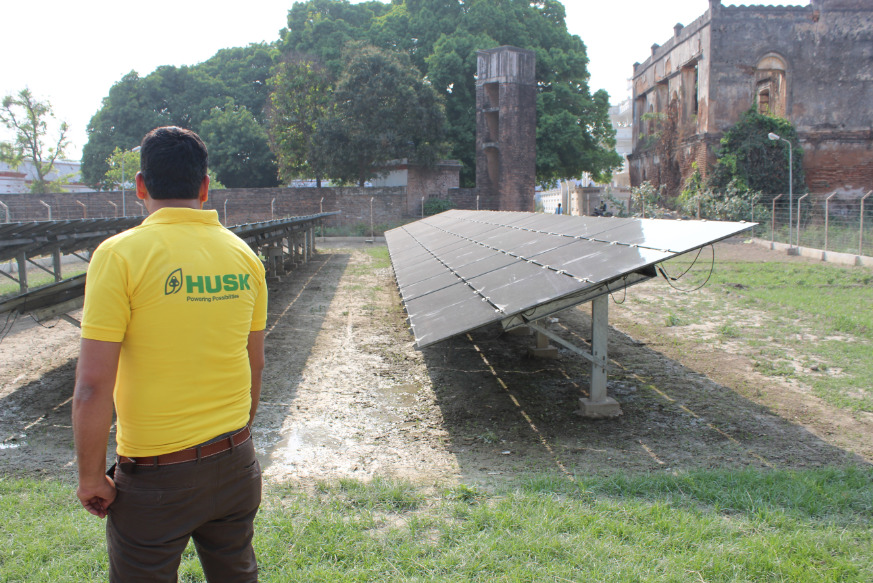 Inspecting the hybrid mini-grid solar modules. Credit: Tom Kenning