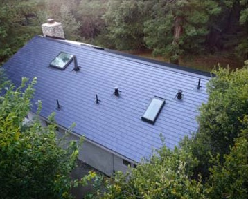 Despite some obvious shading issues from trees, Tesla has started installing its solar roof tile system in the US. Image: Tesla
