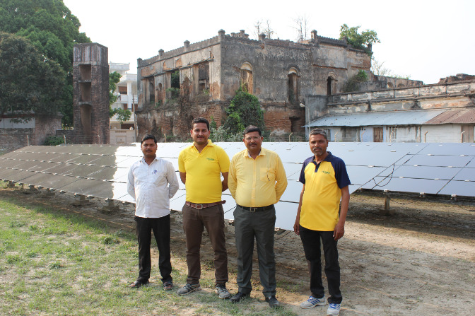 Husk Power Systems' team at its solar, energy storage and biomass mini-grid in Tamkuhi Raj, Uttar Pradesh, India. Credit: Tom Kenning