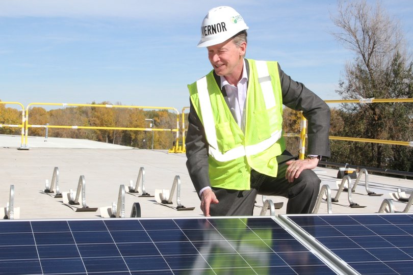 Governor Hickenlooper installing solar panels at the 64kW array. Source: GRID Alternatives