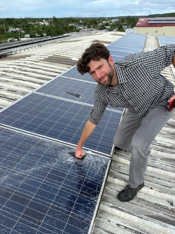 Person throwing a punch at a PV module that has been damaged by extreme weather