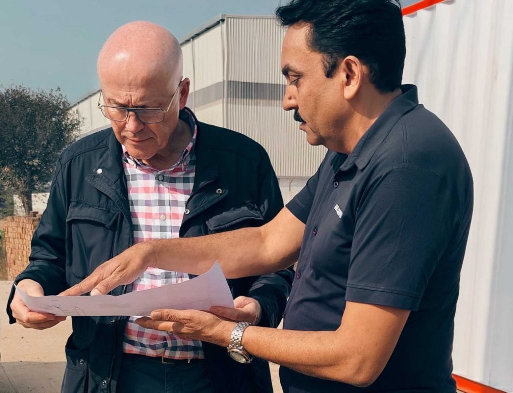 Claude Dagescy (left) and Lalit Kumar Singh (right), discuss 5B and Waaree's manufacturing plant.