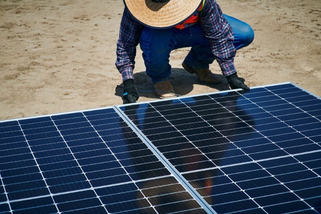 Erthos' site worker installing Earth Mount Solar panels at a PV plant