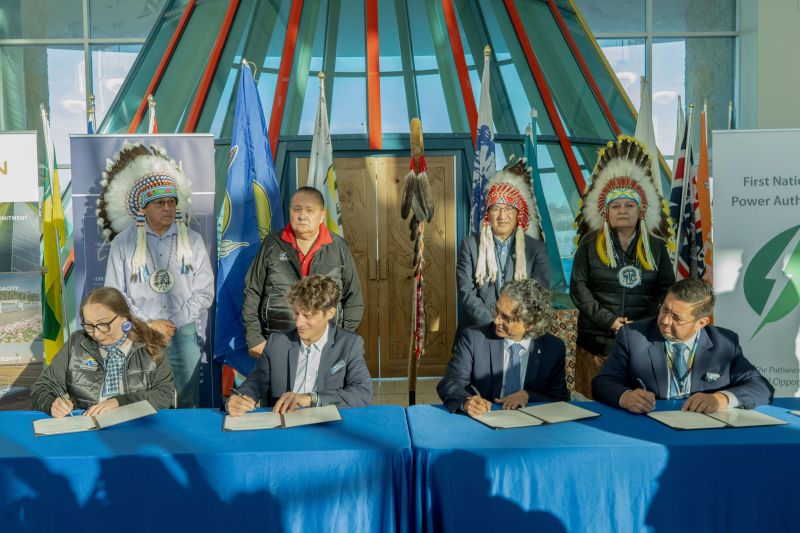 A signing ceremony including Neoen and SaskPower.