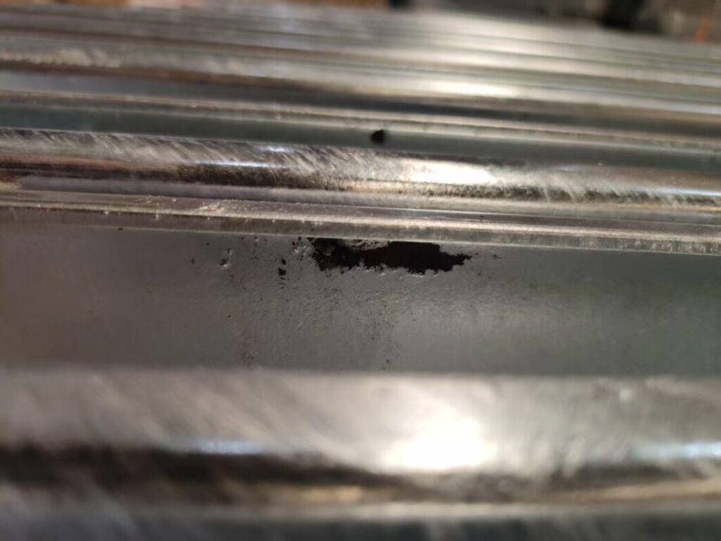 Patchy galvanisation on a structural steel component.