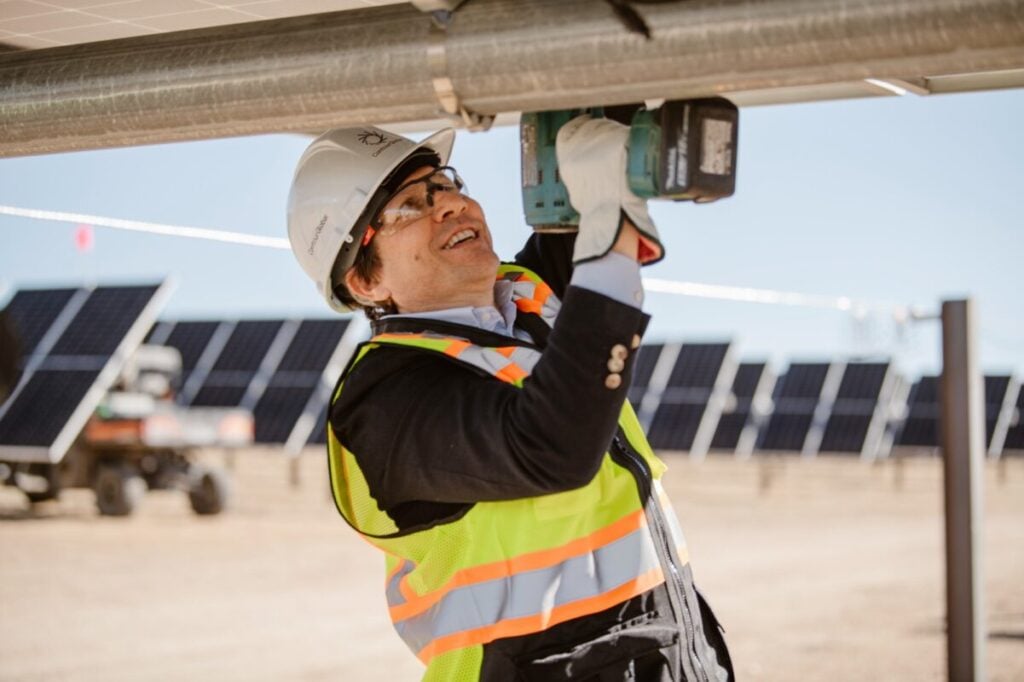 ContourGlobal's CEO installing the last solar panel at the Black Hollow Sun solar project in Colorado.