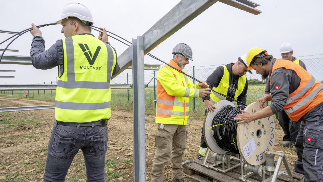 Team of Voltage engineers working with a client on a solar installation.