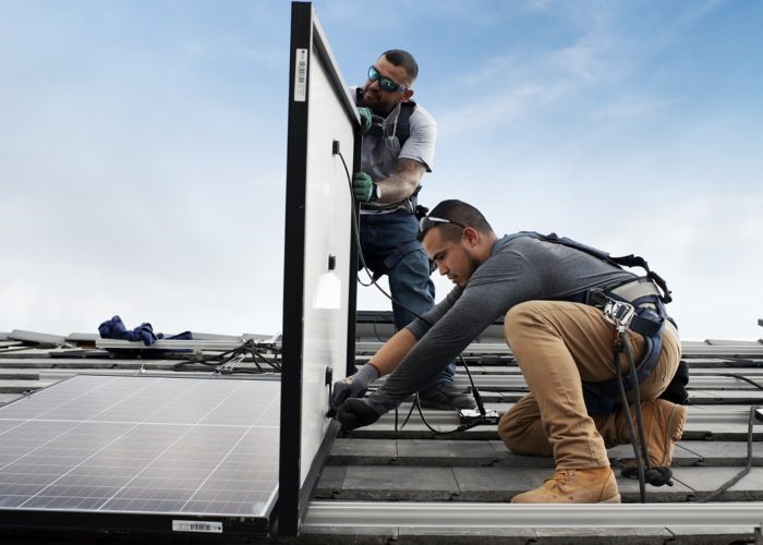 19_Install_Installers_placing_panels_on_roof_close_up