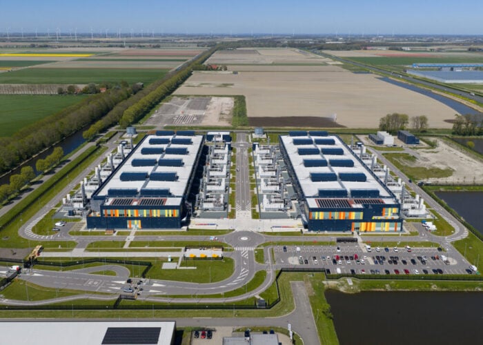 Drone aerial overview of a modern hyperscale datacenter campus in the Netherlands, showing server halls, power and cooling infrastructure, connectivity and cloud operations.