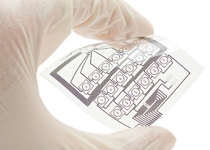 Technician holding a flexible electric circuit layout