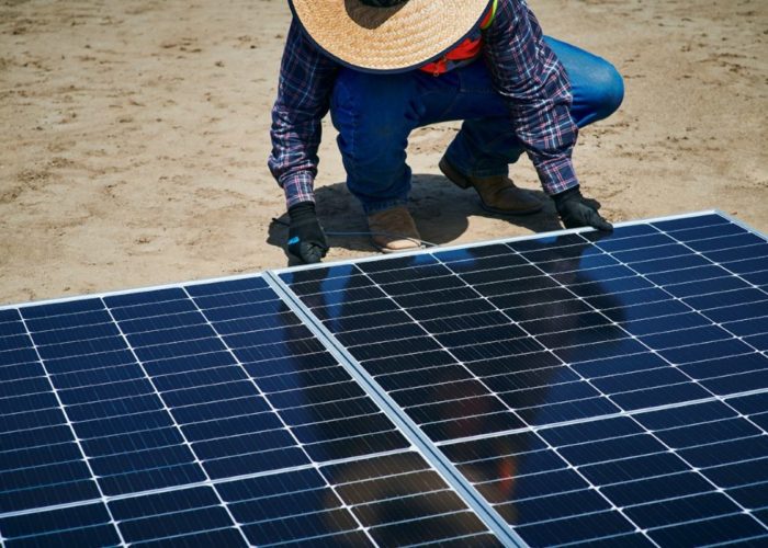 Erthos' site worker installing Earth Mount Solar panels at a PV plant