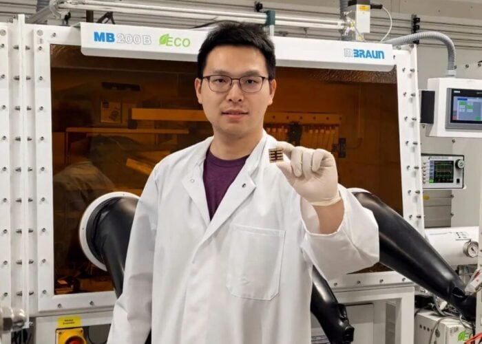 Dr Kun Sun holding a perovskite solar cell.