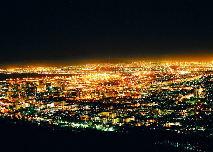 Cape Town at night. South Africa suffers from widespread and frequent grid outages as operator Eskom struggles with reliability. Image: Martie Stewart / Flickr.
