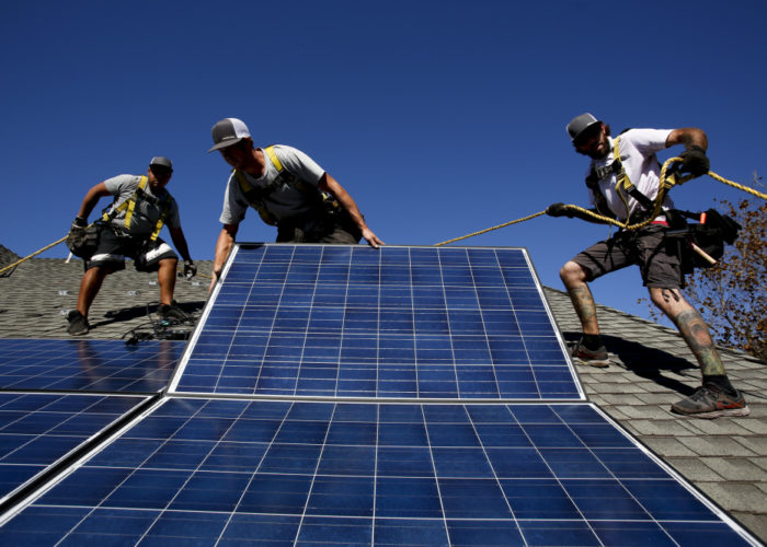 Rogelio Mora (CQ), left, Tyler Smith, center, and Randy Murray, right, workers from vivint.solar in