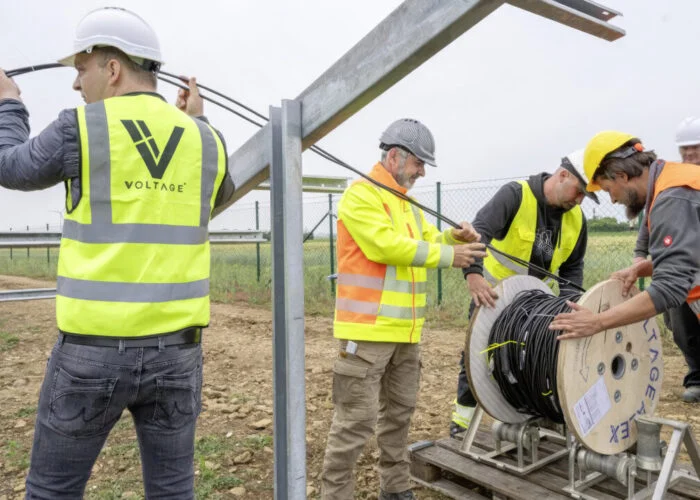 Team of Voltage engineers working with a client on a solar installation.